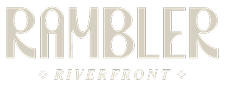 Text logo with the word RAMBLER in large, stylized, beige letters. Below it, RIVERFRONT appears in smaller, capitalized text with decorative stars on either side.
