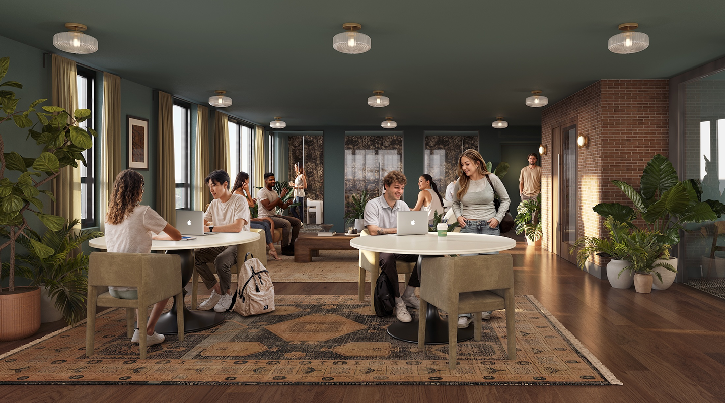 A modern lounge with large windows, green walls, and plants—perfect for Purdue off campus housing. People sit at round tables talking, working on laptops, or relaxing on sofas amid wooden floors and cozy, inviting decor.