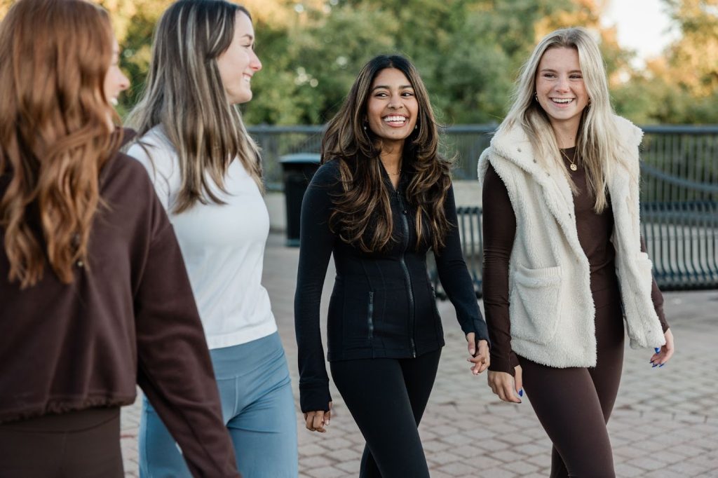Four Purdue students walking together, laughing and chatting in West Lafayette.
