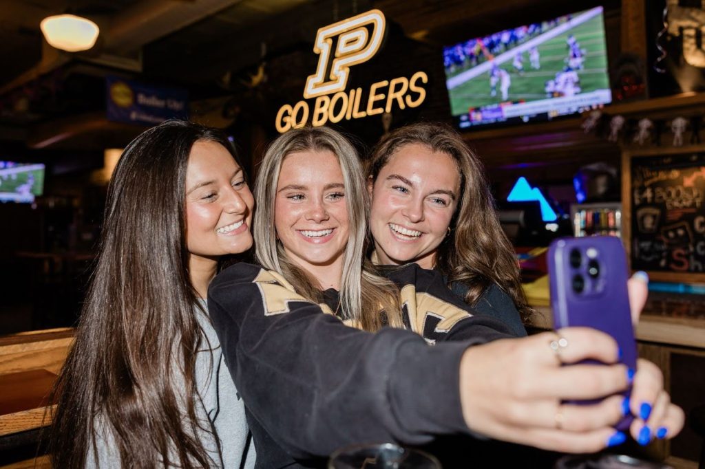 A group of Purdue students taking a picture together in Brother’s off-campus in West Lafayette.