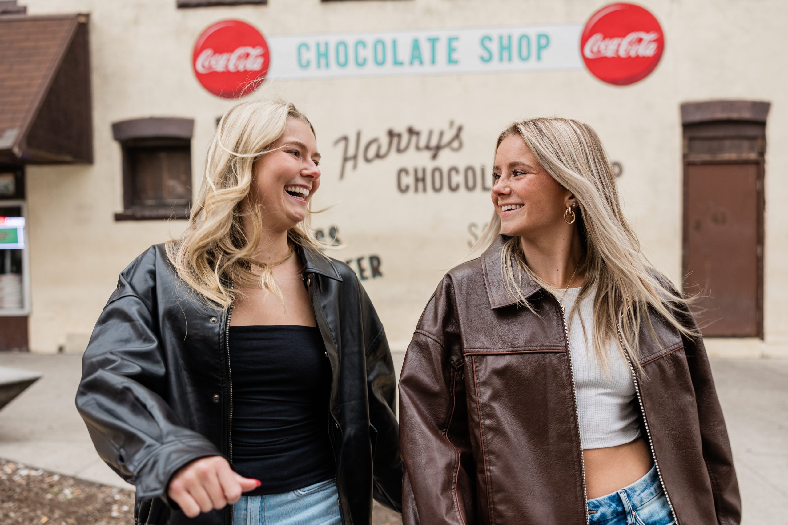 Purdue students laugh together off campus in West Lafayette near Harry's Chocolate Shop.