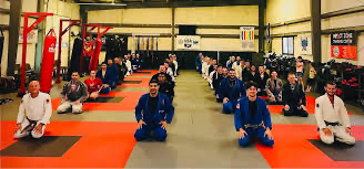 Instructors pose inside the Impact Zone Training Center in West Lafayette.
