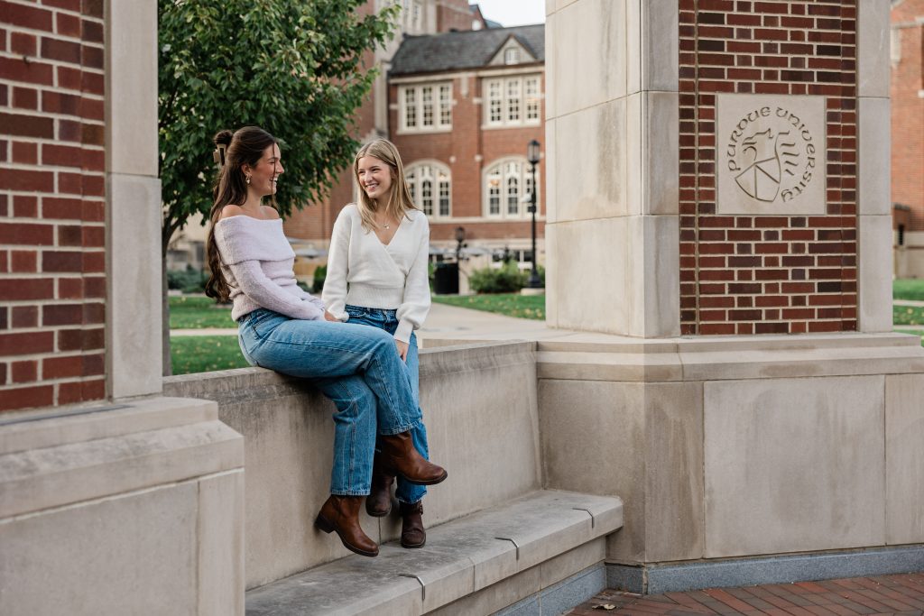 Two Purdue students chatting together on Purdue’s campus. 