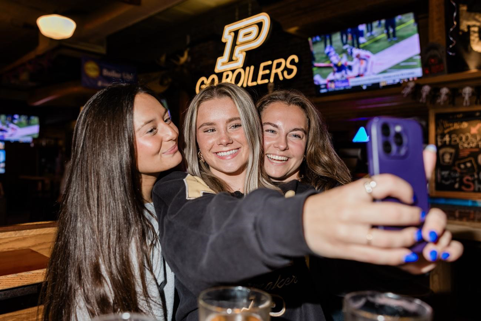 Purdue University students take a selfie off-campus in West Lafayette.