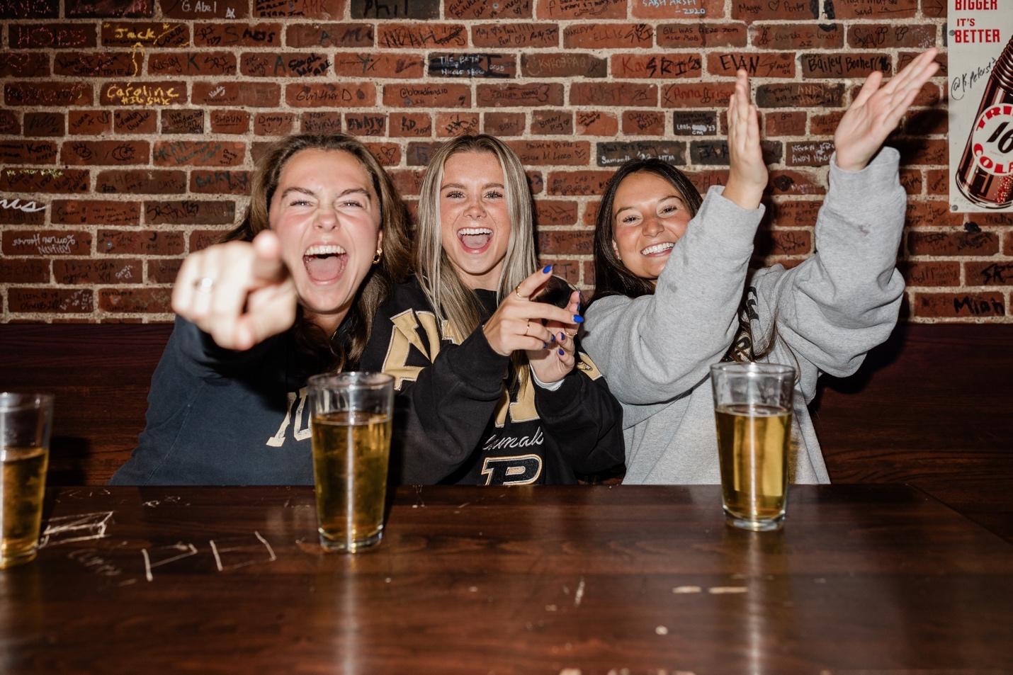Students cheering on Purdue during football season. 