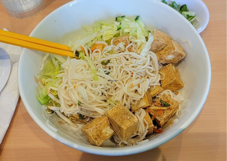 A fresh Vietnamese rice bowl with vegetables and protein. 