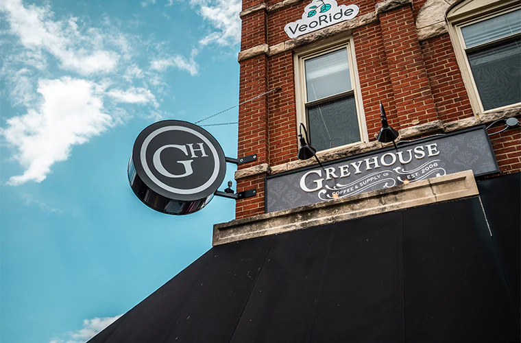 Exterior view of Greyhouse Coffee & Supply Co. building with visible signage, coffee shop in West Lafayette.
