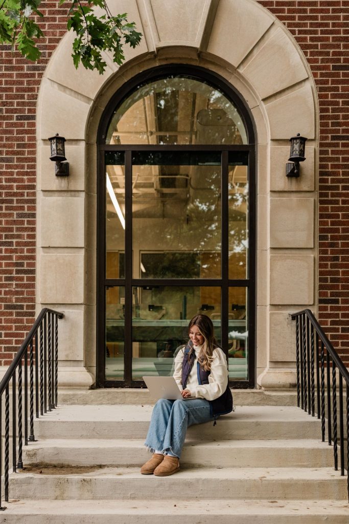 Purdue student working on her computer on Purdue’s campus.