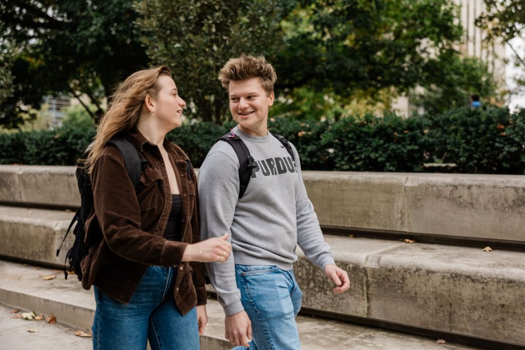 Purdue students walking and talking together on Purdue University’s campus.