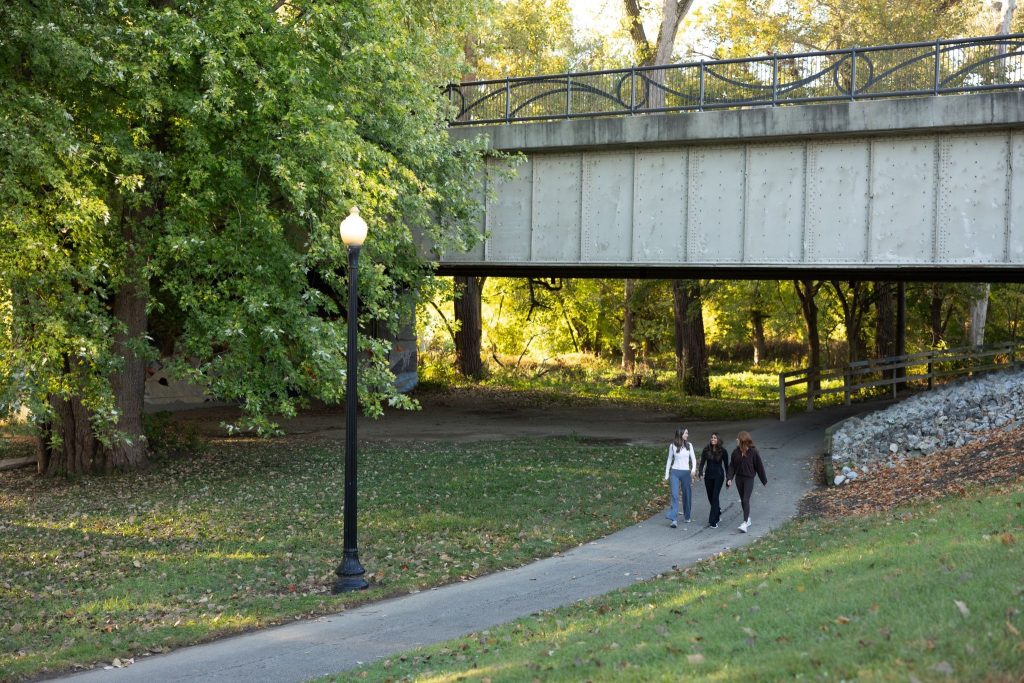 Purdue students walking on a trail near Rambler Riverfront. 