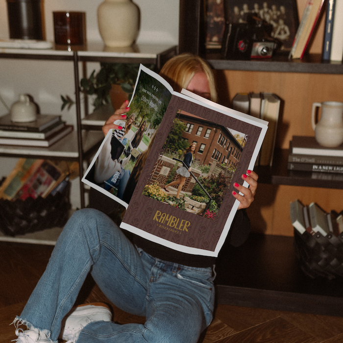Student reading Riverfront Housing Brochure.